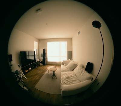 real estate agent recording video with phone, modern apartment background