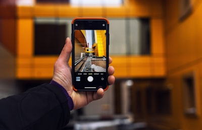 virtual property tour on smartphone, real estate agent pointing at screen