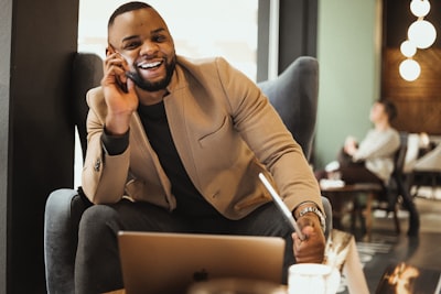 professional real estate agent on phone with client, smiling