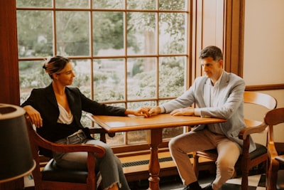 real estate agent shaking hands with happy couple, contract on table