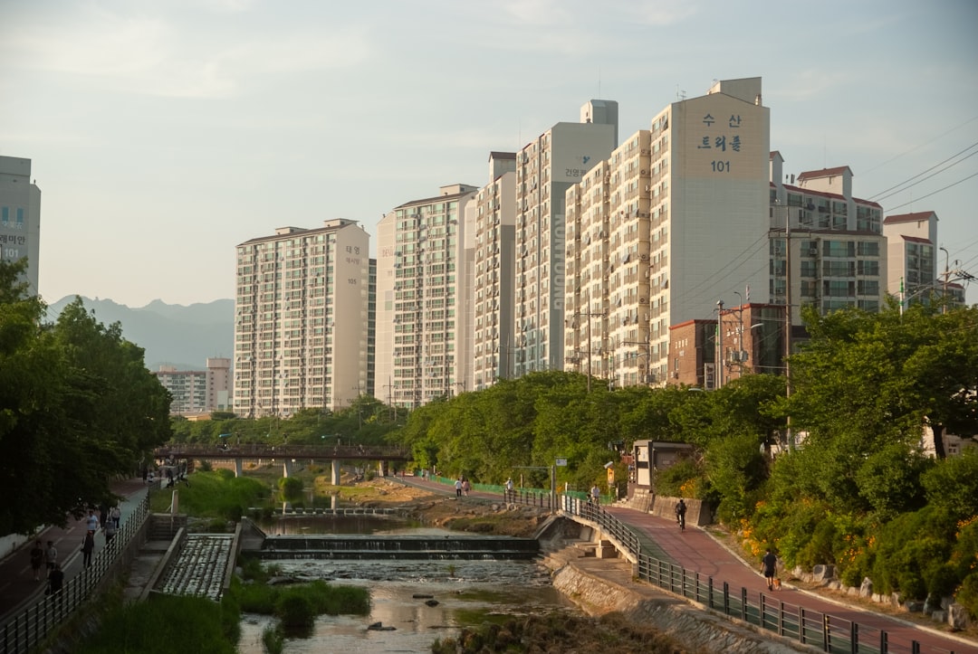 Apartment buildings line the riverbank in the city.