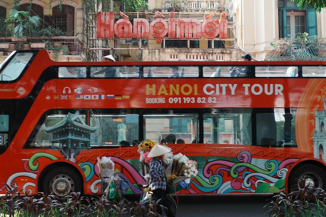 A red tour bus parked in front of a building