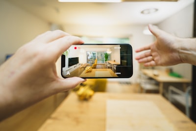 real estate agent filming home tour with smartphone