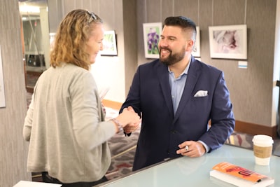 professional real estate agent shaking hands with client