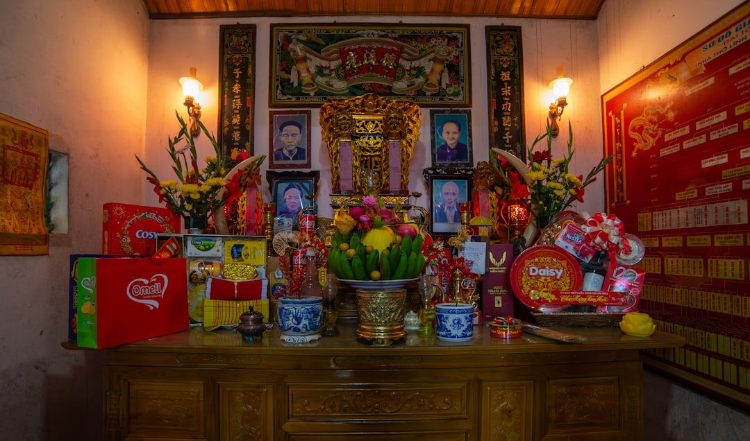 a wooden table topped with lots of vases filled with flowers