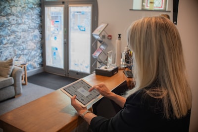 real estate agent using tablet with CRM software, virtual tour on screen