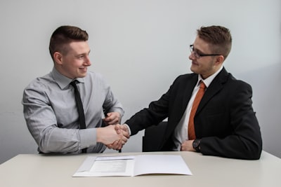 people shaking hands transparent real estate deal