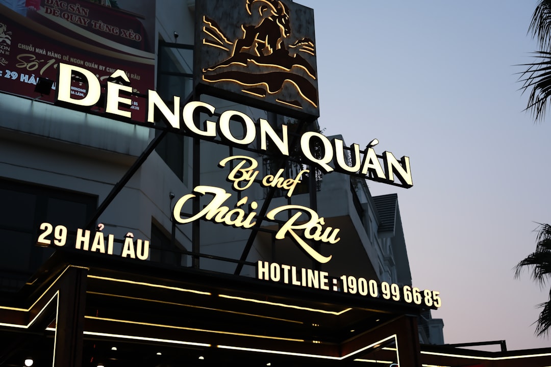 The neon sign for a thai restaurant in the evening
