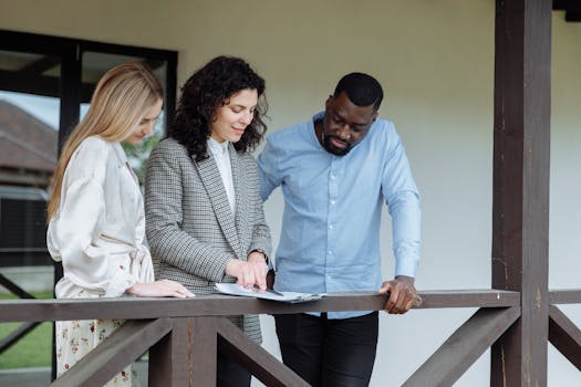 real estate agent explaining property features to a couple