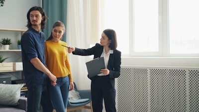 real estate agent showing house to couple