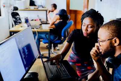 diverse team collaborating, analyzing data on screens