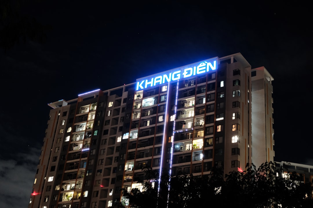 A tall building is lit up at night.