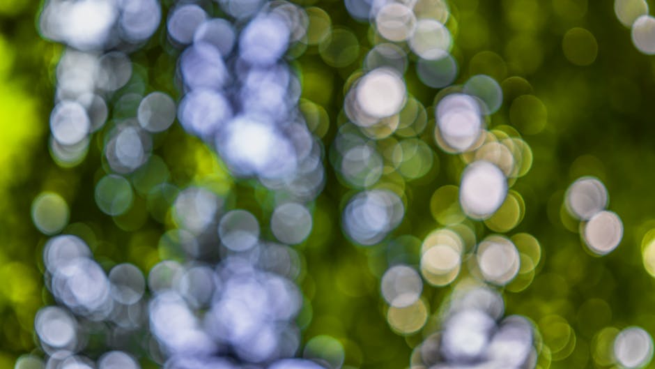 Abstract bokeh background with colorful circles in green and blue hues, ideal for creative use.