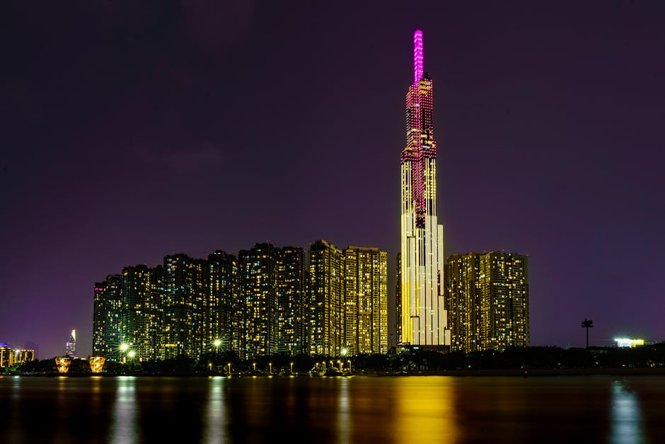 Vibrant night view of Ho Chi Minh City's Landmark 81 tower, lit up against the skyline.