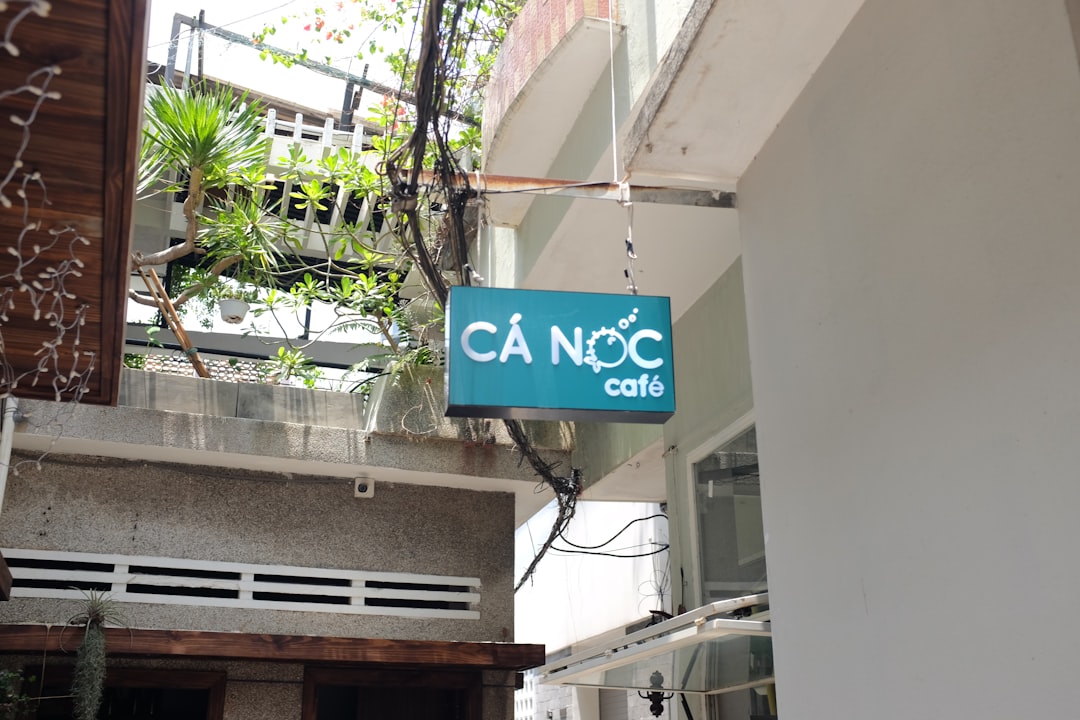 a blue sign hanging from the side of a building
