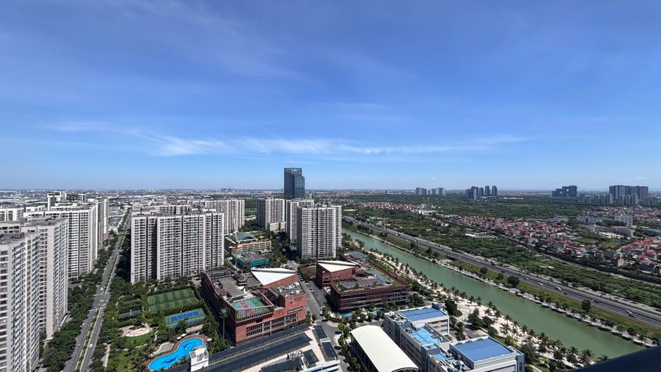 Aerial shot over Hai Phong, Vietnam, showcasing modern high-rise buildings under a clear sky.