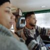Couple using navigation app in a vintage campervan during a road trip.