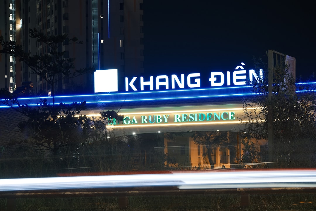 a building with a neon sign that reads kong dien