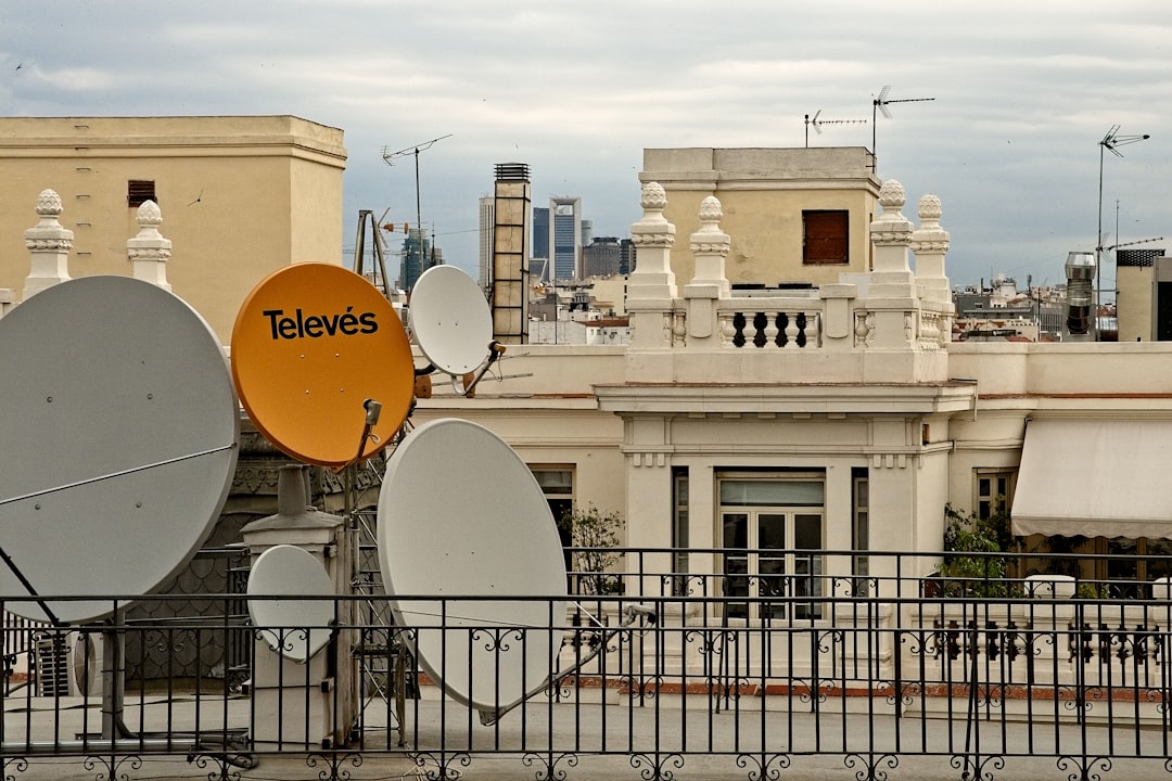 white and orange street sign near white concrete building during daytime