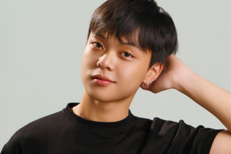 Studio portrait of a young Asian male model in a black t-shirt with a casual pose.