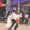 people sitting on bench near road during daytime