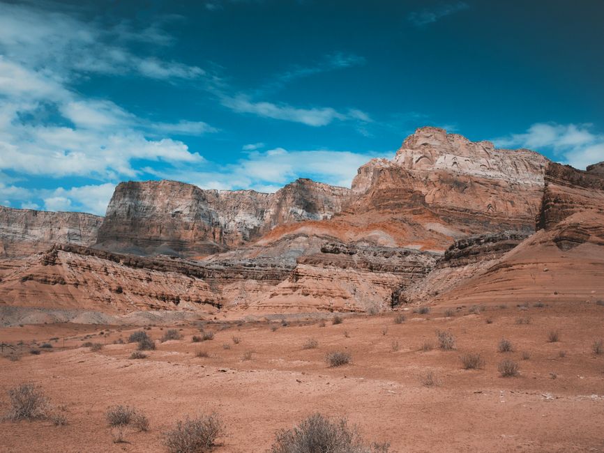 Stunning view of sandstone cliffs under a bright sky in Marble Canyon, Arizona.