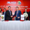 Two businessmen shaking hands at a signing ceremony event